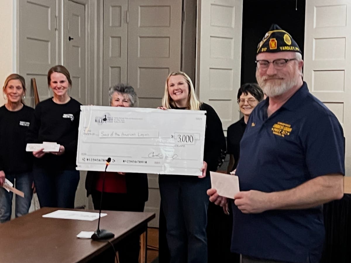 Yardley Parks and Recreation Department Chairwoman Akvile Montvilaite holds a $3,000 check presented to the American Legion at Tuesday night's Borough Council meeting.