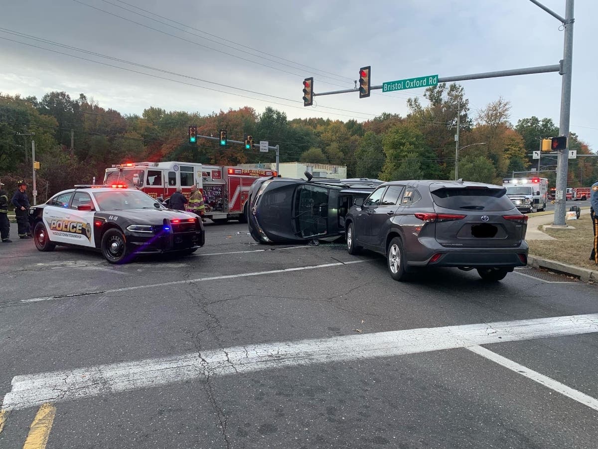 Fire crews worked to free two people who were trapped in a car on its side early Tuesday morning at the intersection of Bristol Oxford Valley and Trenton roads.