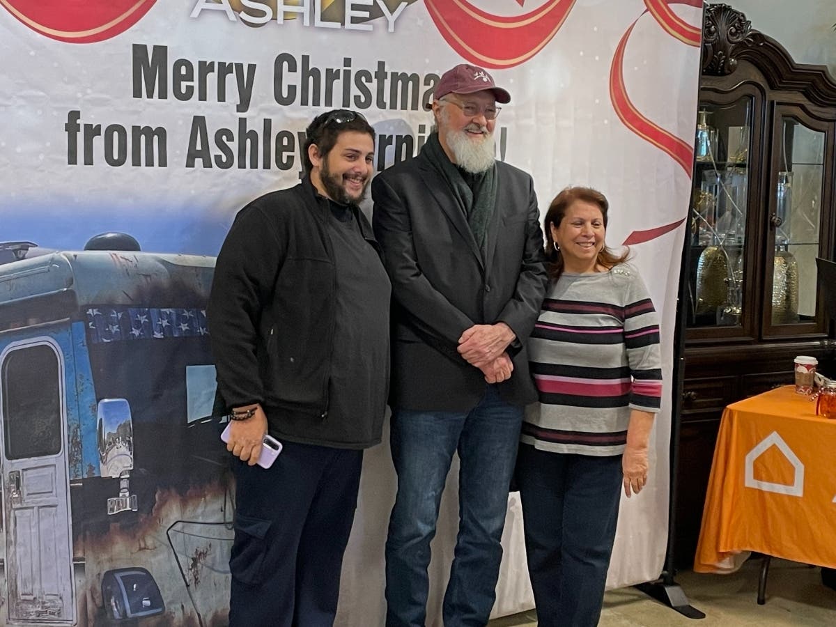 "Cousin Eddie" actor Randy Quaid posed with fans of the "Christmas Vacation" movie during a promotion by Ashley Furniture on Saturday.