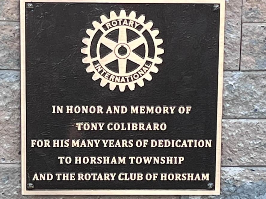 Horsham Township officials placed a plaque at the foot of the Blue Light tree in a ceremony last week to honor a late community member.