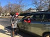 A volunteer driver delivers food collected on her early morning route.
