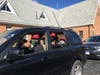 The D'Souza family gives a big "thumbs up" after a morning of collecting food left on the doorsteps of community neighbors.