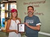 Karen Joseph, Cofounder of Food For Neighbors, presents Great Harvest Bread Company owner Ken Marter with a plaque in recognition of his company's steadfast support for the past five years.