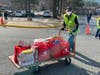 Lisa Nahill was one of several volunteers transferring Red Bag food donations from vehicles to tables for sorting.

