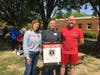 Karen Joseph (left), Founder of Food For Neighbors, celebrated the nonprofit's partnership with Irving Middle School representatives Cynthia Conley (middle), Principal and David Rolls (right), Family Liaison. Irving is the food hub for area schools.