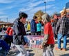 At Luther Jackson Middle School, volunteers receive, sort, and deliver 4,850 pounds of food and toiletries collected by 28 drivers and their helpers from 353 nearby households. 