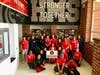 Sorting volunteers at Herndon Middle School celebrate their hard work with a fun, group photo. They sorted donations from two generous food drives plus over 3,287 pounds of food and toiletries collected by 20 drivers and their helpers from 248 households.