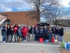 Businesses make a difference with Food For Neighbors! Here, 17 representatives from Pyramid Systems, a Food For Neighbors partner, celebrate a morning of volunteering together to provide supplemental food for local students. 
