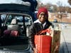 A young volunteer enthusiastically helps unload car after car of donated food and toiletries for students attending Key MS, John R. Lewis HS, Thomas A. Edison HS, Washington Irving MS, and West Springfield HS. 