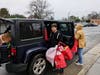 The rain doesn't stop dedicated volunteers from unloading car after car full of food and toiletry donations to help students in need.