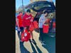 Volunteers unload car after car with red bags full of food and toiletry donations from Sterling and nearby neighborhoods.