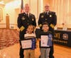 First Place Winners Thigpen Student Mason Polanco and Cunningham Student Jorge Aguilera with Joliet Fire Chief Jeffery Carey and Deputy Chief John Stachelski