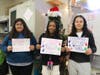 (From left to right) Hufford students Alejandra Ramirez, Leah Collins, and Jimena Ulloa made signs to encourage their classmates and teachers to donate socks.