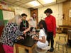 Images, Inc. Director of Business Development Janet Henderson, Chase Robinson, V2 Companies Civil Engineer Heidi Voirol, Permedia Carr, and Emily Johnson test the strength of the student water tower.
