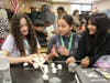 (From left to right) Valeska Castellano, Ericka Vasquez Henriquez, and Sofia Perez Camargo discuss their ideas to build a strong water tower. 