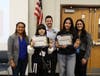 Joliet Public Schools District 86 Deputy Superintendent Dr. Tanisha Cannon, Board of School Inspector Matthew Pritz, and Science and Social Science Coordinator Tori Bailey congratulation the double-gold winners Emily Gutierrez and Alisson Gaitan Lopez.