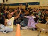Kindergarten student Celina Silva enjoys the confetti during the all-school assembly.