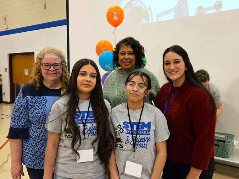 (From left to right) Joliet District 86 Superintendent Dr. Theresa Rouse, Assistant Superintendent Dr. Ankhe Bradley, and Science Coordinator Tori Bailey congratulate Dirksen students Samantha Trujillo and Nathaly Velazquez on their perfect score.