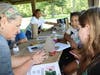 (From left to right) University of Illinois Extension Center Horticulture Educator Nancy Kuhajda examines a soldier beetle with Edna Keith Elementary School students Isabella Turner and Carly Hall at Pilcher Park Nature Center.