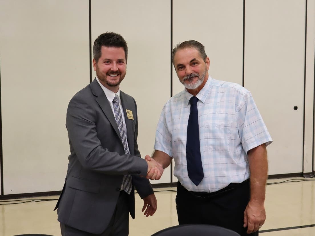 Andrew Smith (right) is welcomed to the Joliet District 86 Board of School Inspectors by school board president Matthew Pritz. 


