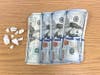 Fake crack cocaine and counterfeit money seized in arrest. 