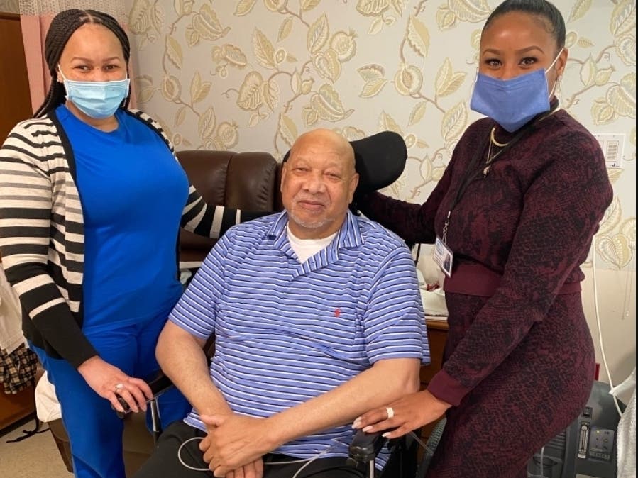 John Ormond contracted COVID-19 while working at Whispering Pines Nursing & Rehabilitation Center. After 130 days hospitalized, he's returned to stay. He's pictured with his daughters: Ashanti, a nursing scheduler and Savonna, assistant nursing director. 