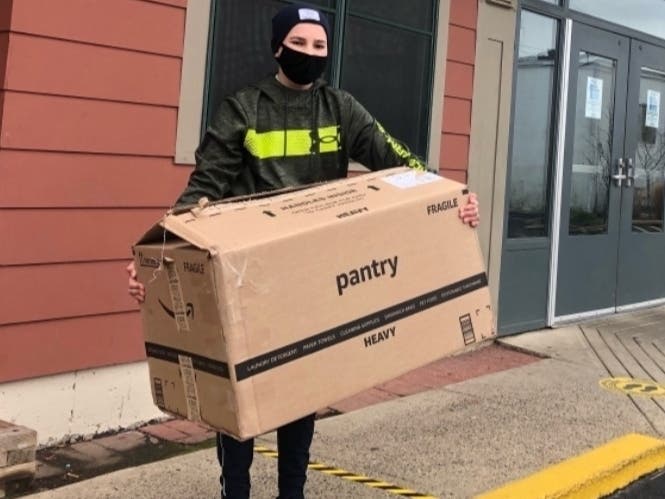 Cooper Schwartz delivers beanies and other warm winter gear to the Columbus House homeless shelter in New Haven. 