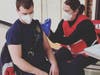 An East Haven firefighter receives the Moderna COVID-19 vaccine. 