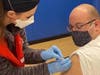 Guilford firefighter/paramedic Joe Deko receives the Moderna COVID-19 vaccine in Madison last month as part of a collaboration between three health departments to vaccinate first responders. 