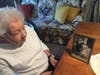 Marie Streeto will turn 103 when she gets her second dose of the COVID-19 vaccine on March 20. Here, she looks fondly at a photo of her parents, both of whom were infected with flu in 1918. An infant, she stayed with family until her parents recovered.