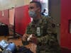 A CT National Guard member assists people at the Fair Haven Community Health mass COVID-19 vaccine clinic in New Haven Wednesday.
