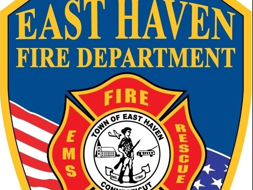 A one-acre brush fire was reported early Monday afternoon behind Tweed New Haven Airport that's presented access issues for firefighters necessitating a call for mutual aid.