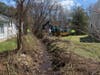 Public works staff cleaning up the brook.