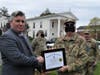 Selectman Cosgrove receives a certificate for his service.