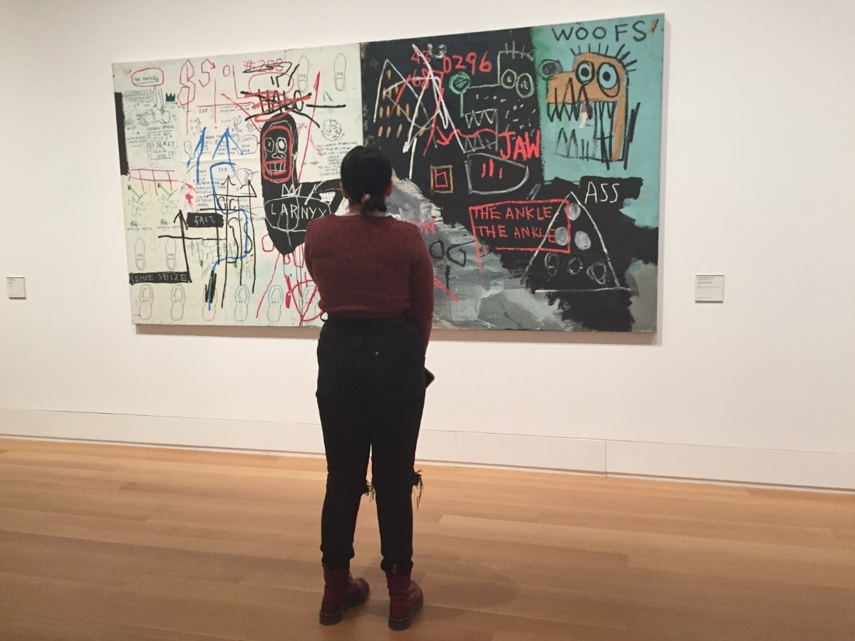 A visitor views a painting by Jean-Michel Basquiat in the Yale University Art Gallery.