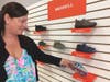 Sarah Deko shows some of the children's shoes she carries in her new store, Madison Ave. Children's Shoes in Branford.