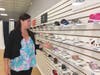Sarah Deko shows some of the children's shoes she carries in her new store, Madison Ave. Children's Shoes in Branford.
