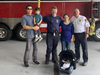 The family visited the firehouse to say thank you. Pictured (l. to r.) Sam, Webster, Firefighter/ Paramedic Chris Jones, Maya, Firefighter/Deputy Fire Marshal Captain Jim Considine, and Baby Niobe Ren.