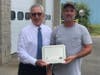 First Selectman Matt Hoey presents Parks Supervisor Anthony Annicelli with the award.
