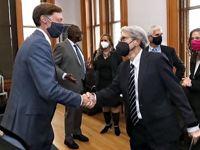 New Haven Mayor Justin Elicker and Yale President Peter Salovey shake hands after Tuesday's announcement at City Hall.