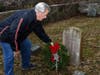 Branford Recreation Director Alex Palluzzi Jr. places a wreath at the stone of a Civil War vet at Damascus Cemetery.