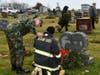 Veteran Phil Zielinski comforts firefighter Jeff Masci who places a wreath at his grandfather's grave.