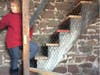 Heidi Manely climbs the steps to the top of the steeple in the Old Stone Church.