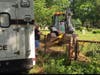 East Haven's public works department drove a backhoe to Hamden to dig. 