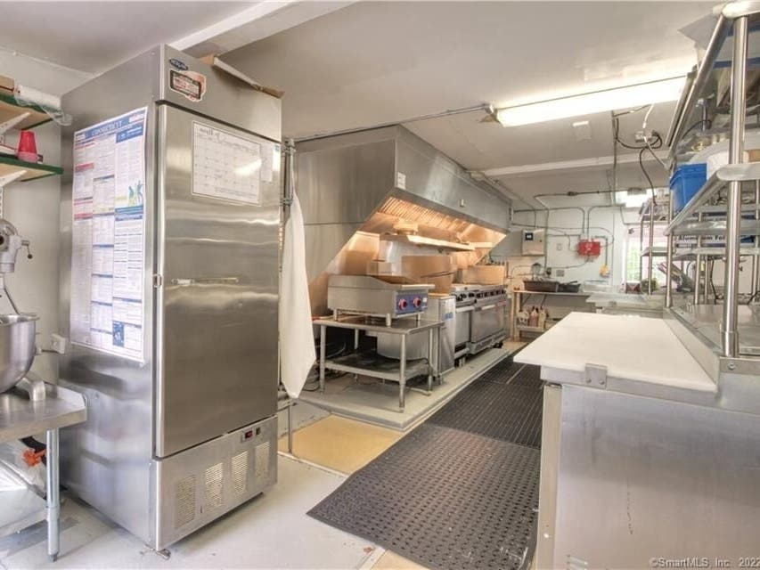 Listed by Page Taft/Compass agent John Campbell, the 251 Boston Post Road site is in a residential zone, but has for years been home to a restaurant, as seen in the photo of a large commercial kitchen, albeit long designated a club.