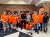 Volunteers and Home Depot staffers fill go-buckets at East Haven High School.