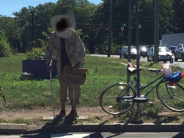 An elderly, disabled and homeless man stands at the corner of MLK and Grasso near the West River, one scene of the city's move to dismantle and remove the tents and belongings of people living in encampments. 