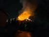 Smoke and fire visible from the side of a building extending into the attic space upgraded the call to a structure fire, according to the fire department.
