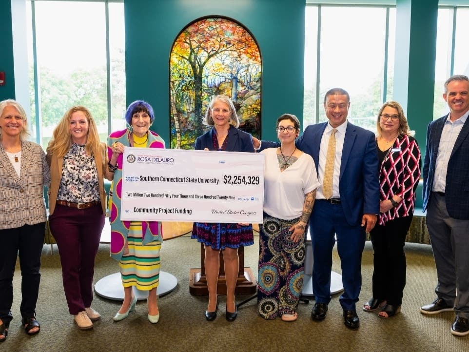 Suzie Huminski, Dr. Colleen Bielitz, U.S. Representative Rosa DeLauro, Dr. Sandra Bulmer, Jenni Myers, Brett Sandman, Amy Feest, and Garrett Sheehan celebrating $2.25M in federal funding for The Hive.