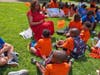 Educators and volunteers read with kids. 